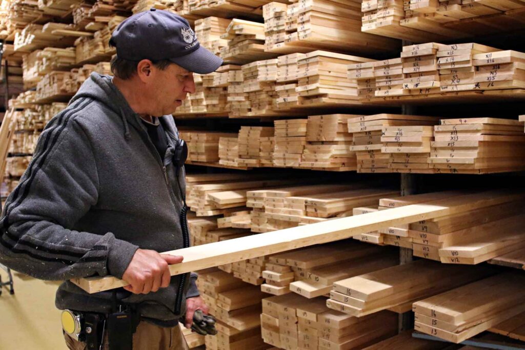 Roy Thompson shows vertical grain boards at RBM Lumber in Columbia Falls, Montana. (AP Photo/Flathead Beacon, Greg Lindstrom)